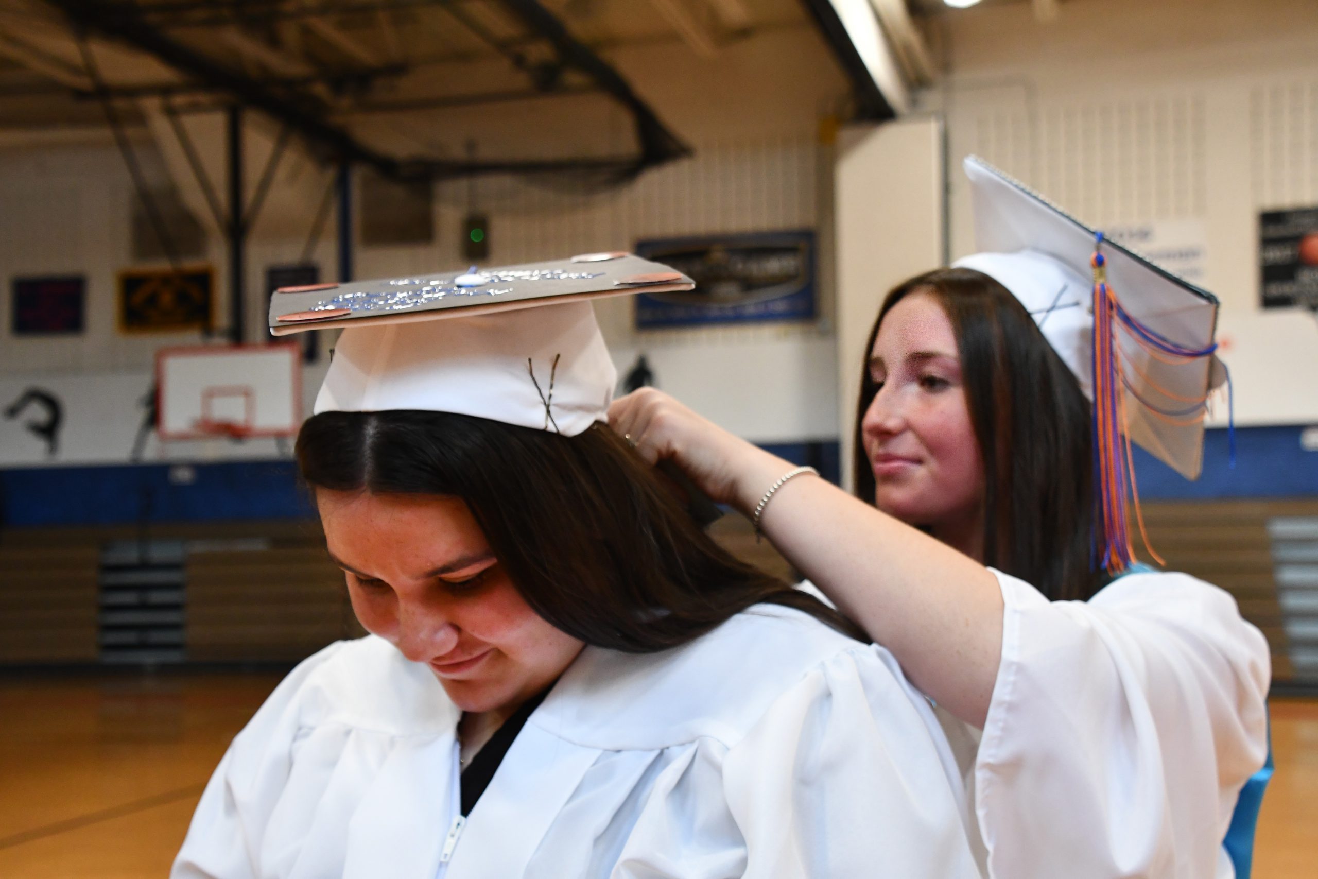 Melissa Cutrona helps Adriana Joy secure her cap