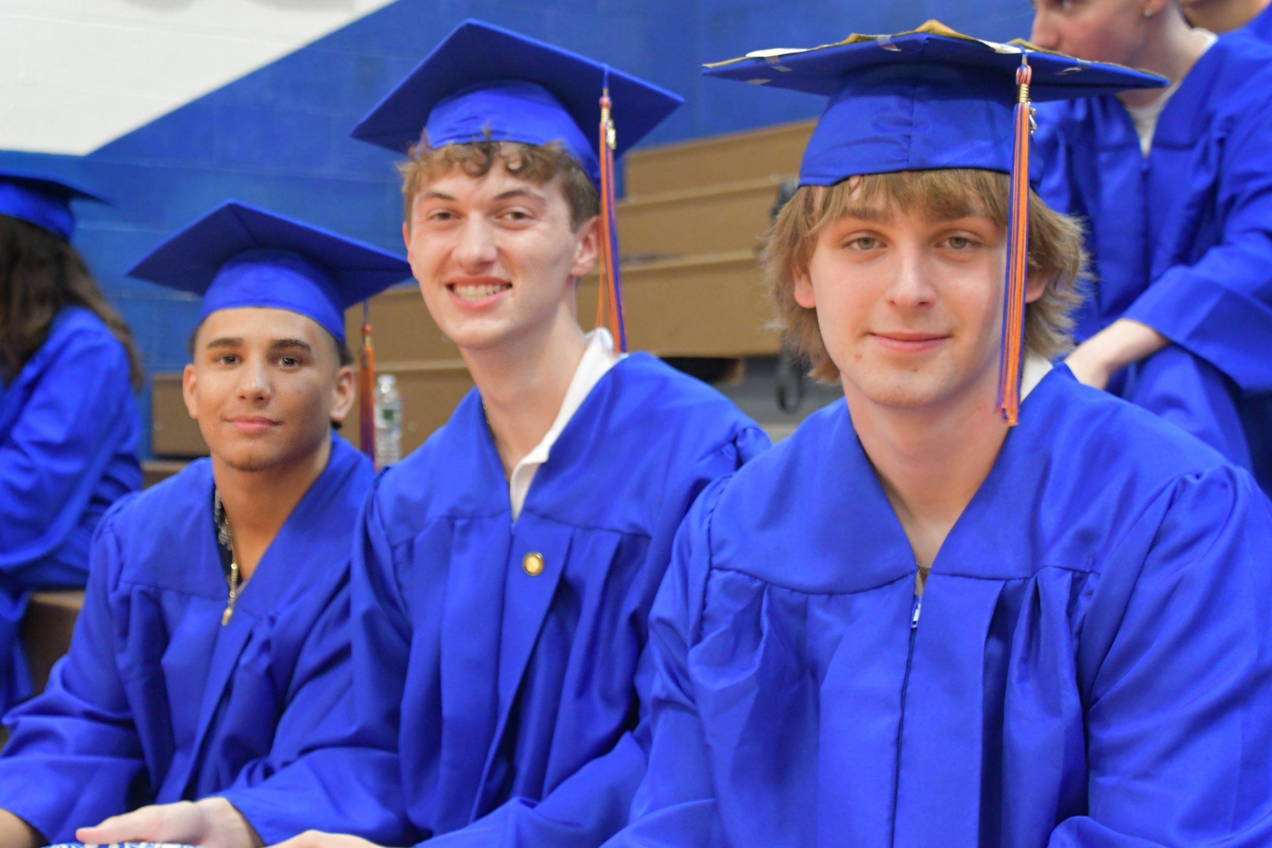 Three students prepare for graduation