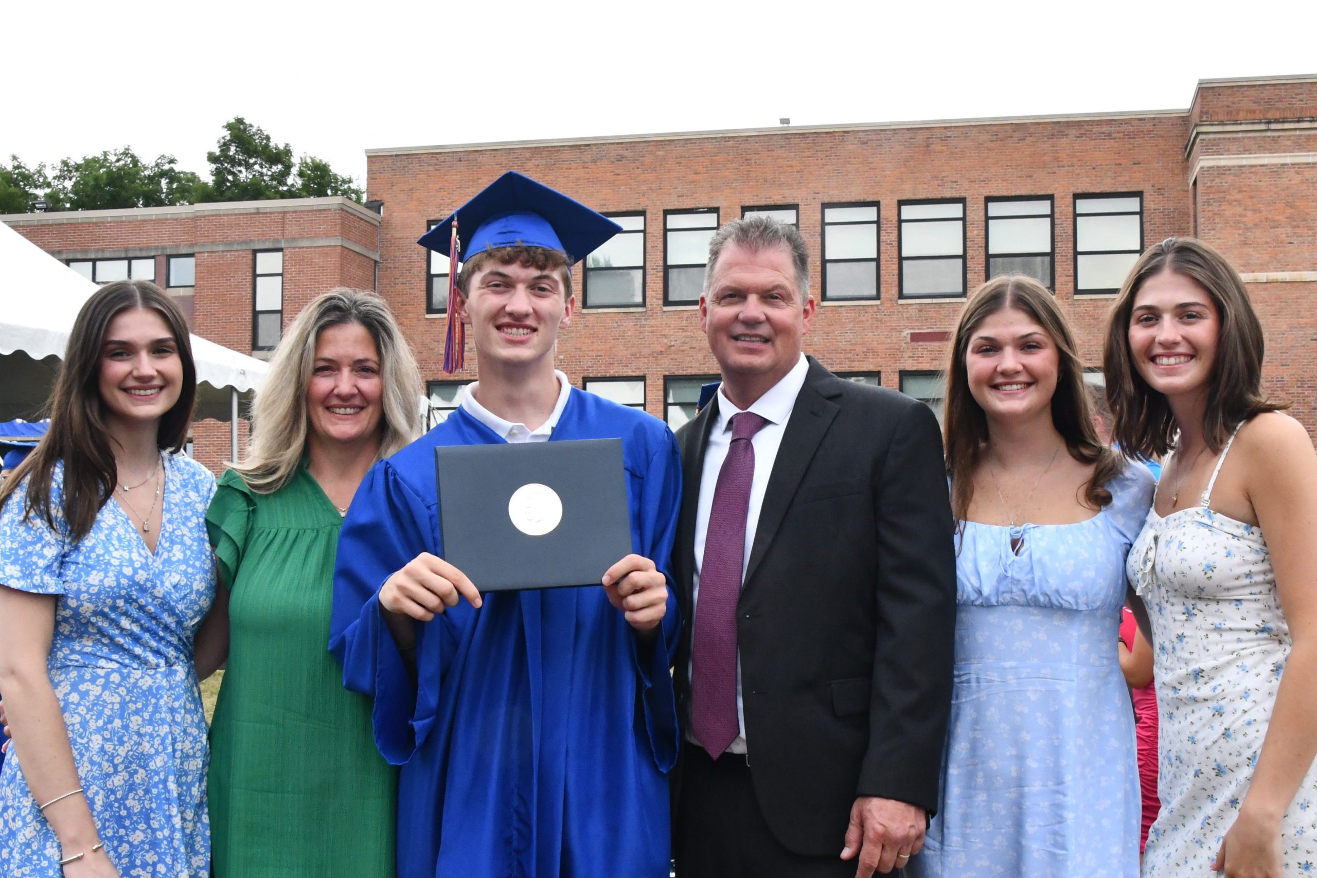 family poses with graduate