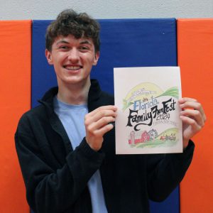 Joseph Melody hold up his artwork for the Florida Family Fun Fest Cover