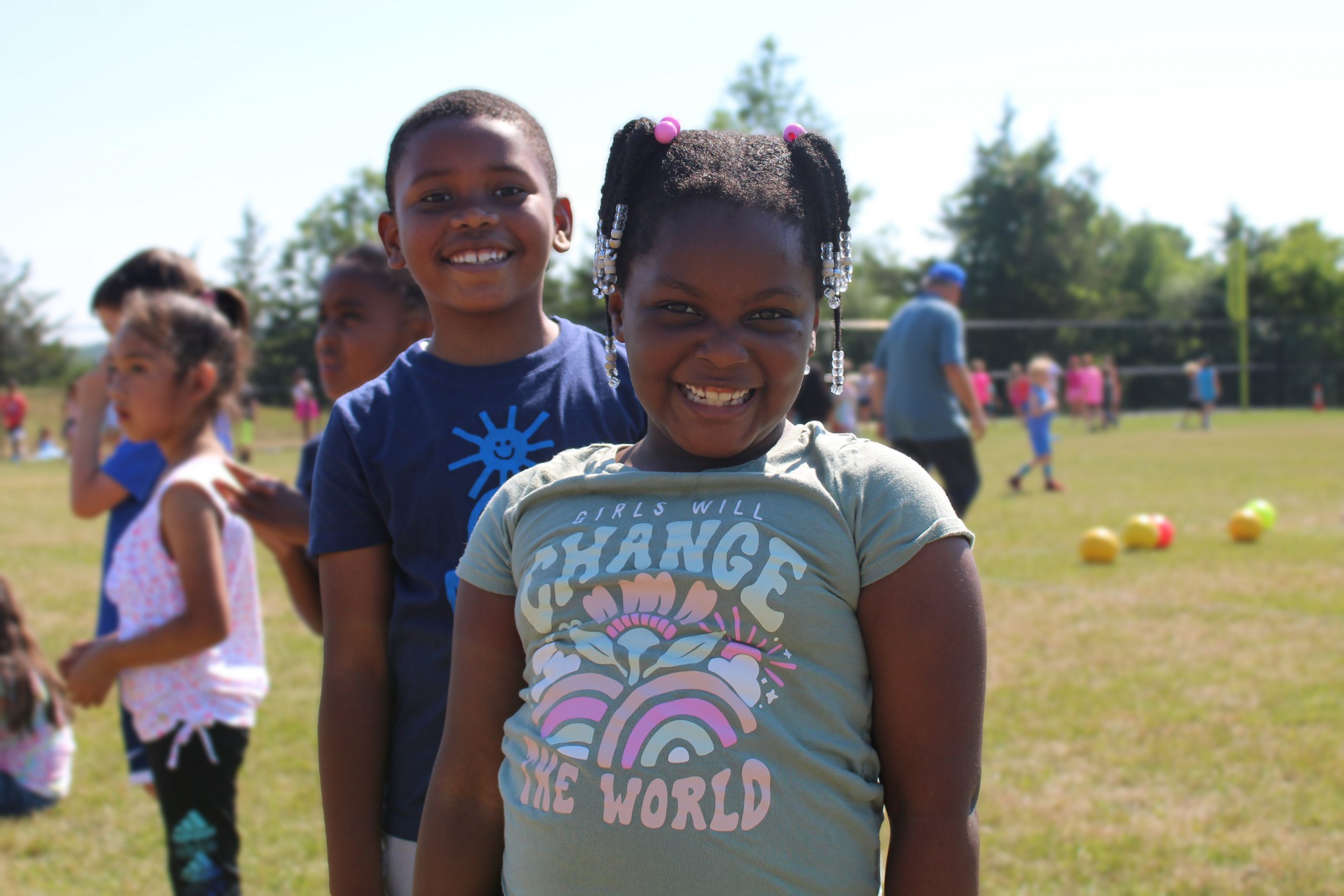 a boy and a girl smile at field day