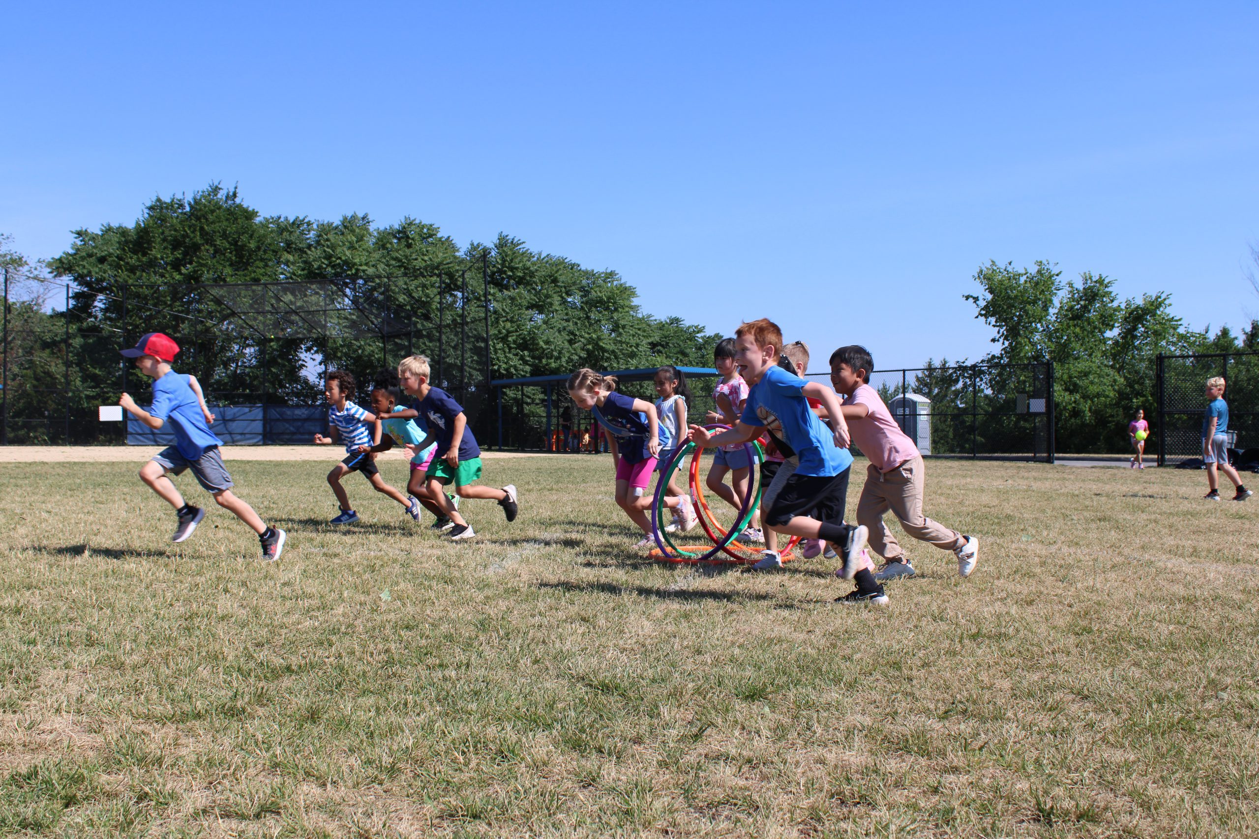 Students run on the field at field day