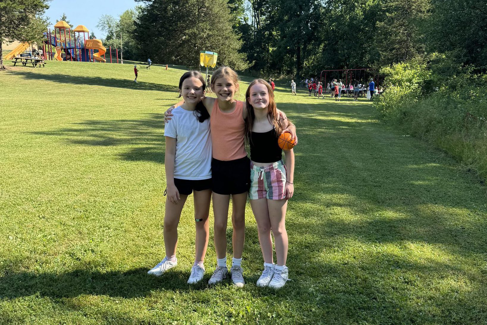 three fifth graders pose for a photo at field day