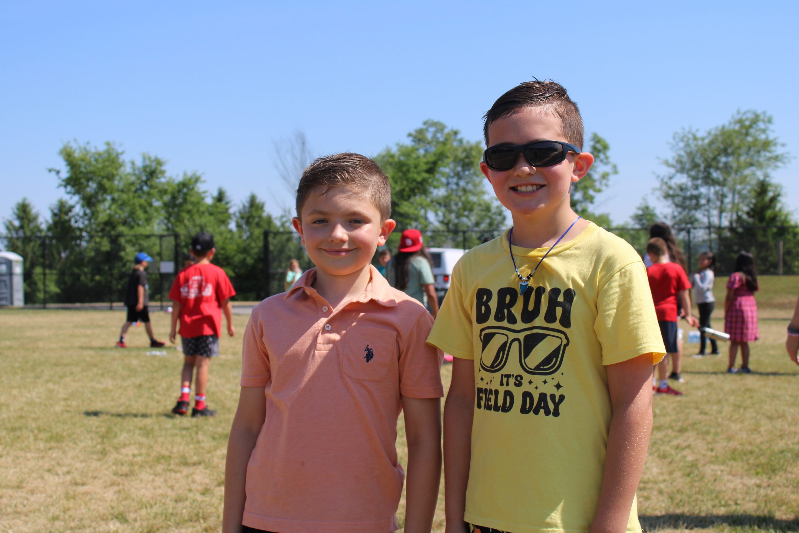 Two boys smile at field day