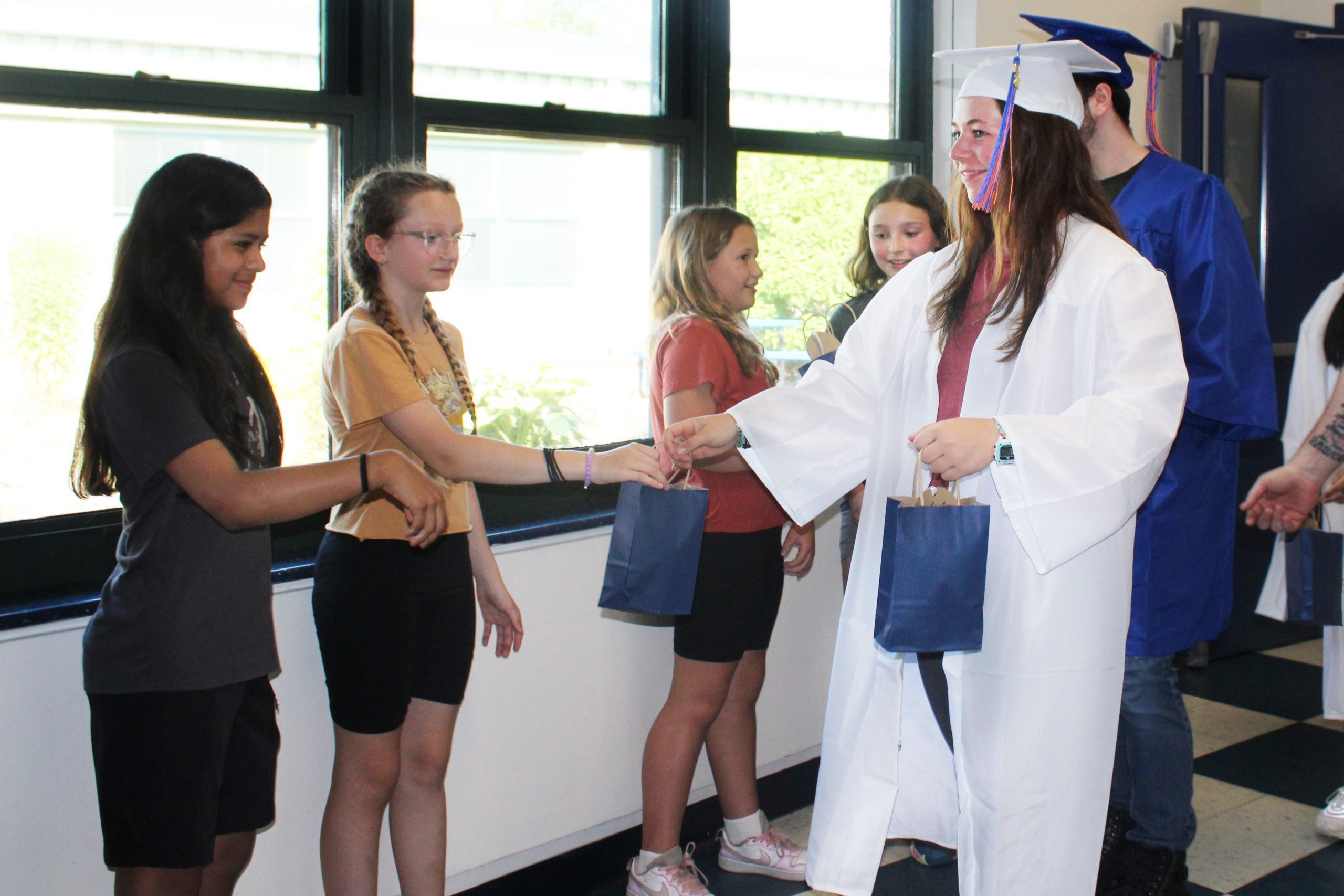 Stephanie Reicherter hands out gift bags to 5th graders at Golden Hill