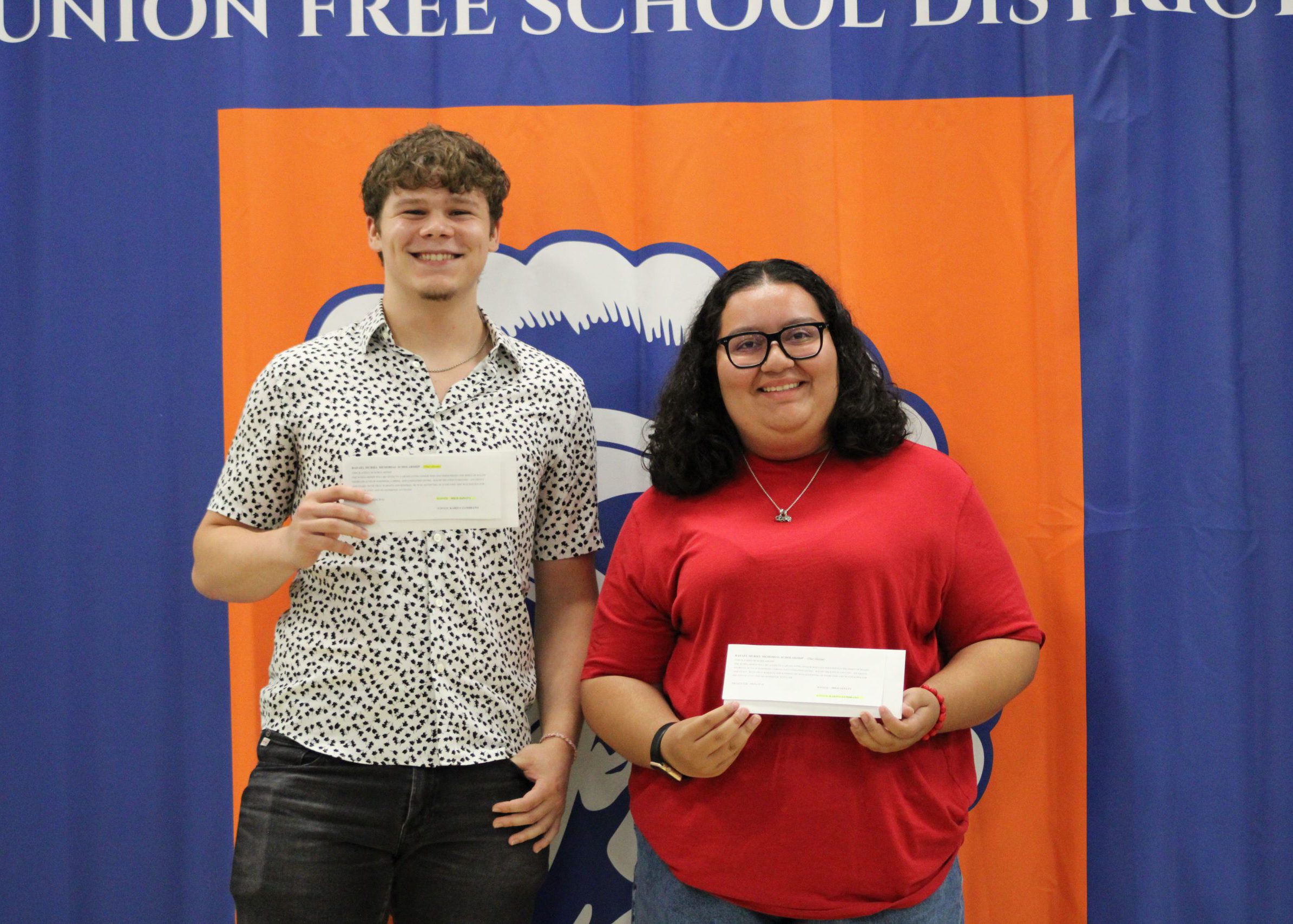 three students pose with their awards