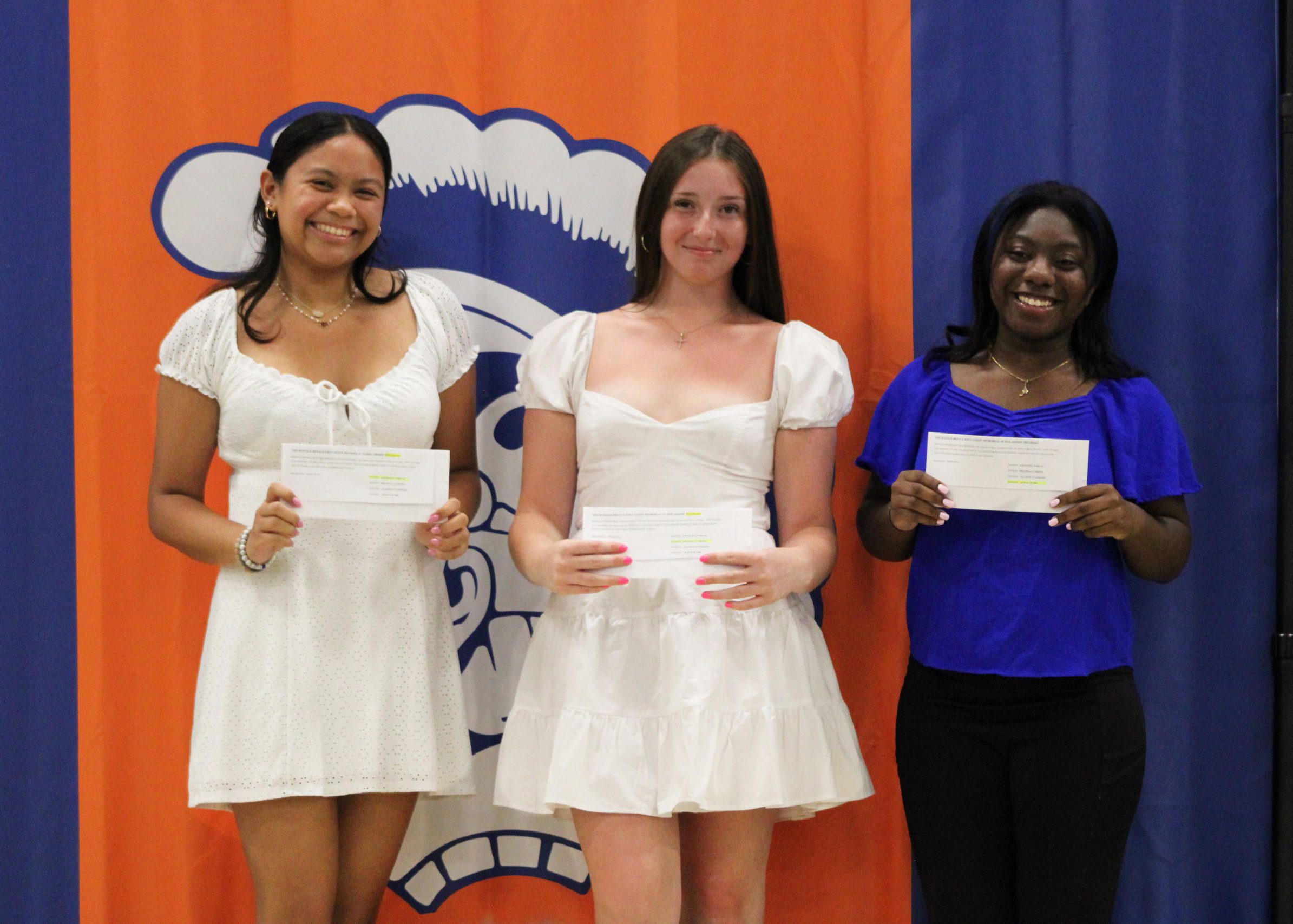 three students pose with their awards