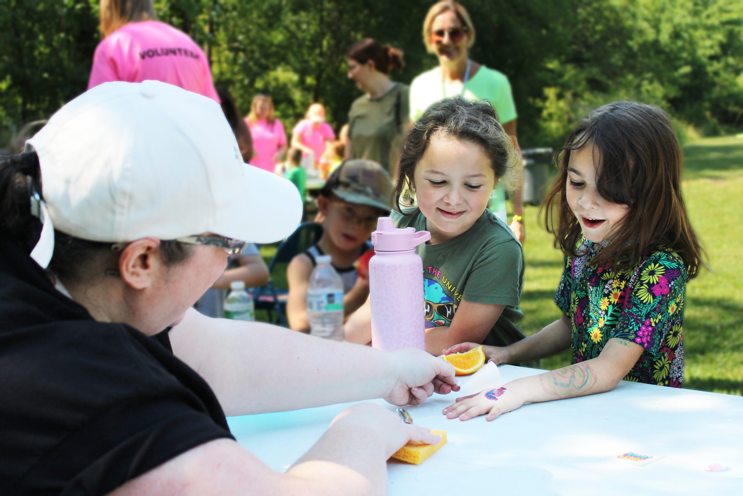 student gets a temporary tattoo at field day