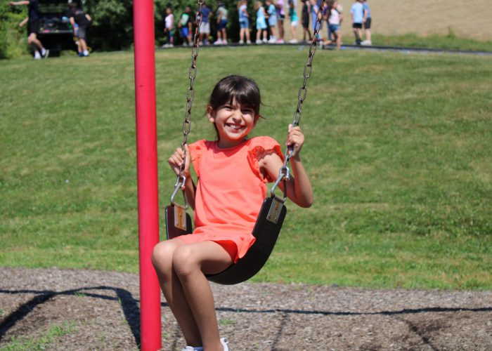 student on a swing at field day