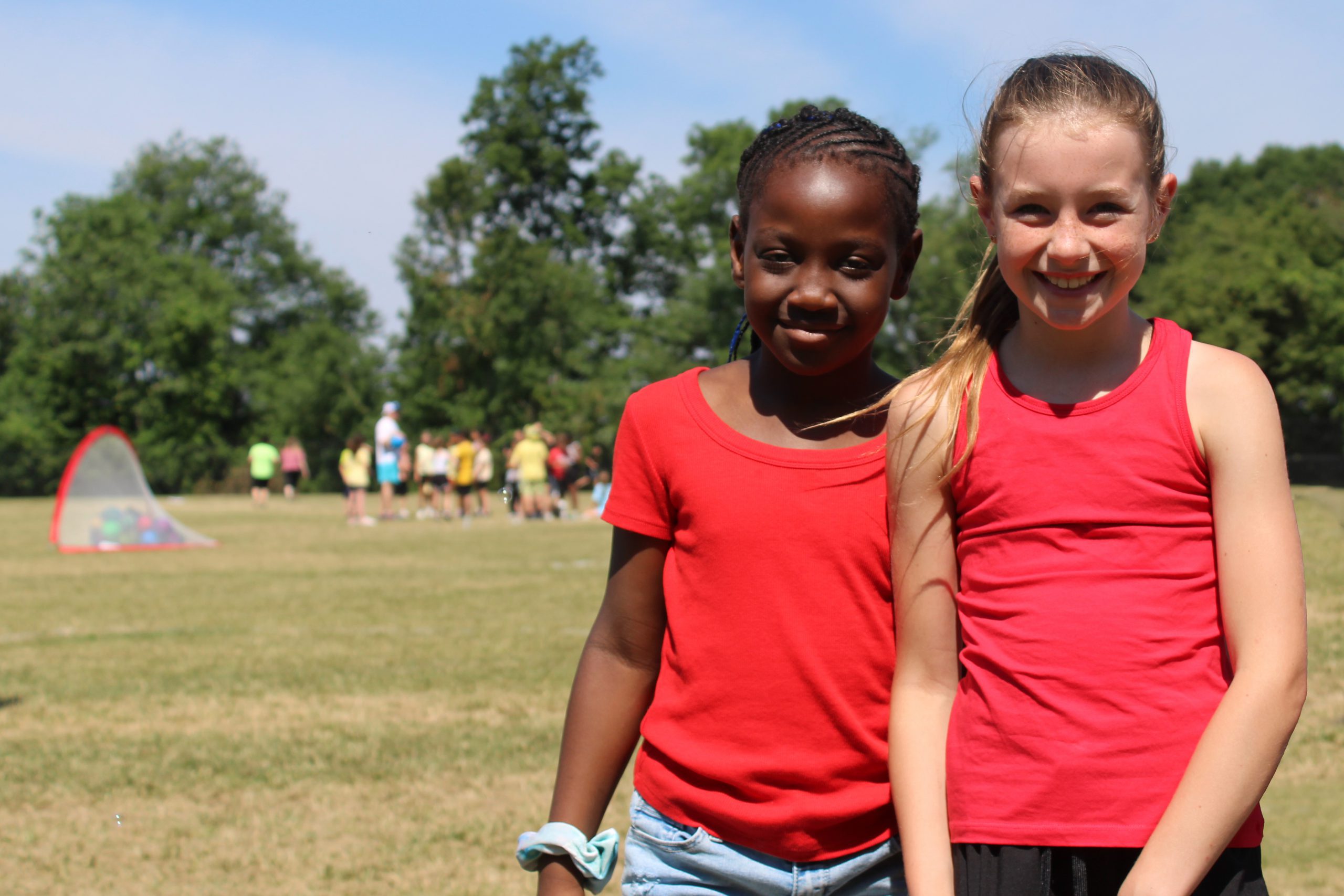 two students smile on field day
