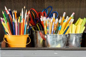 image of school supplies including colored pencils, scissors and highlighters