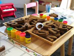 playroom including wooden letters and play-doh