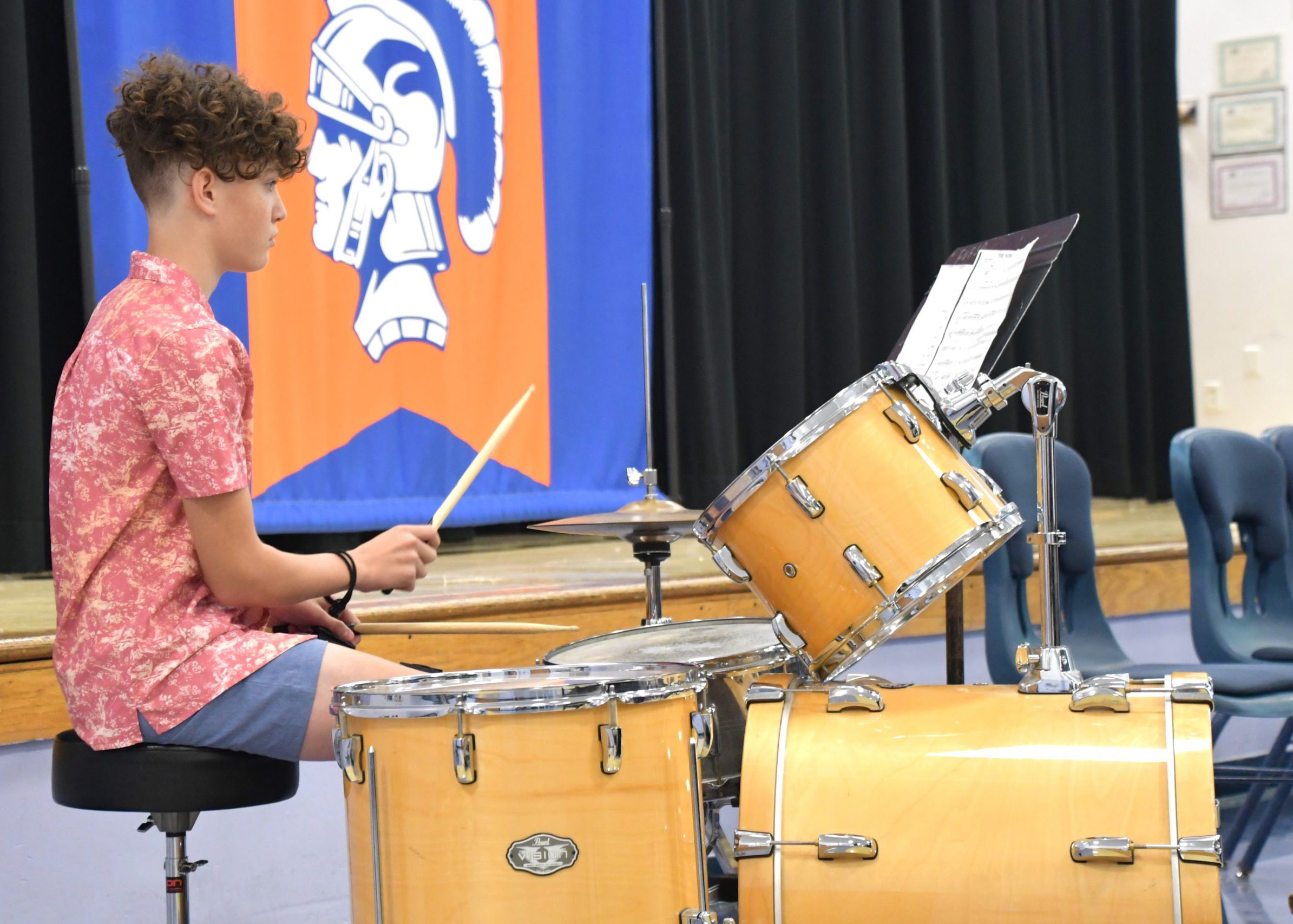 High school percussionist plays the drums