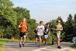 Cross country team runs up the hill at Golden Hill