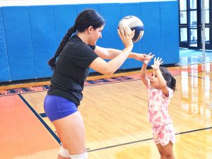 Jackie Tomassi teaches student to set