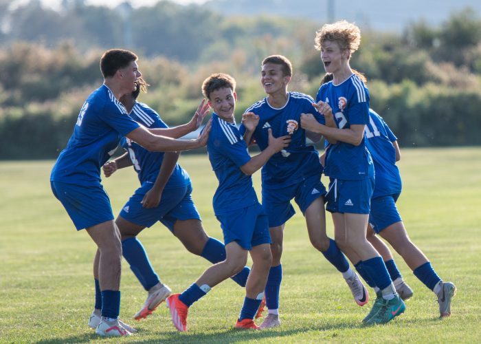 Varsity soccer players celebrate after a great play on the field