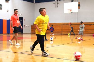 students work on soccer ball control in gym enrichment