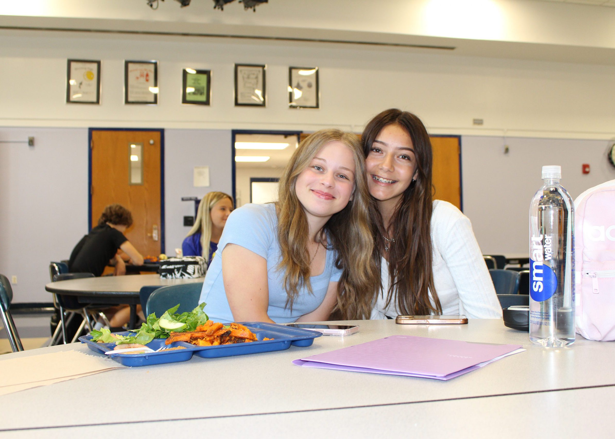 students smile for the camera at lunch