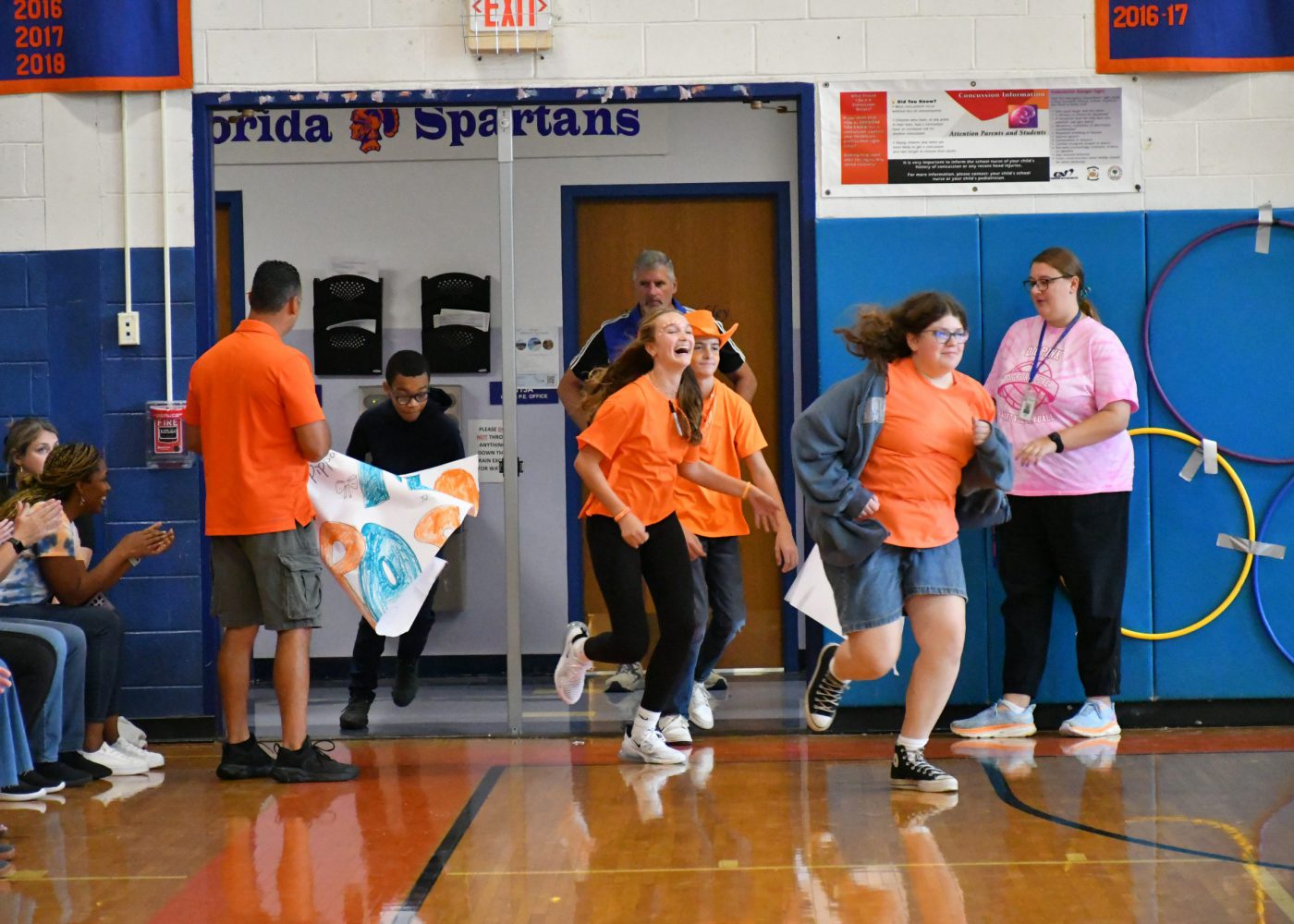 teams make an entrance into the pep rally