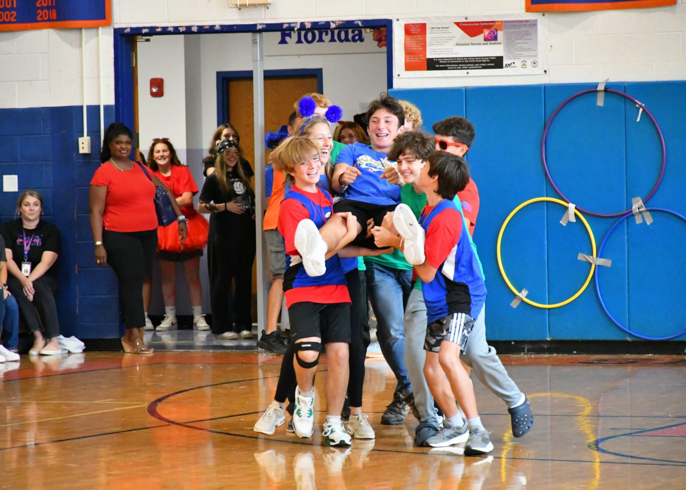 teams make an entrance into the pep rally