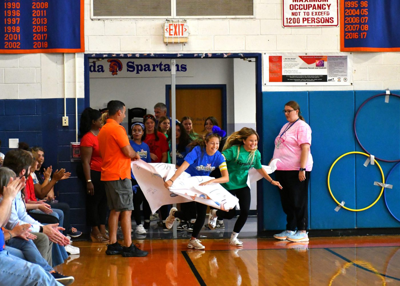 teams make an entrance into the pep rally