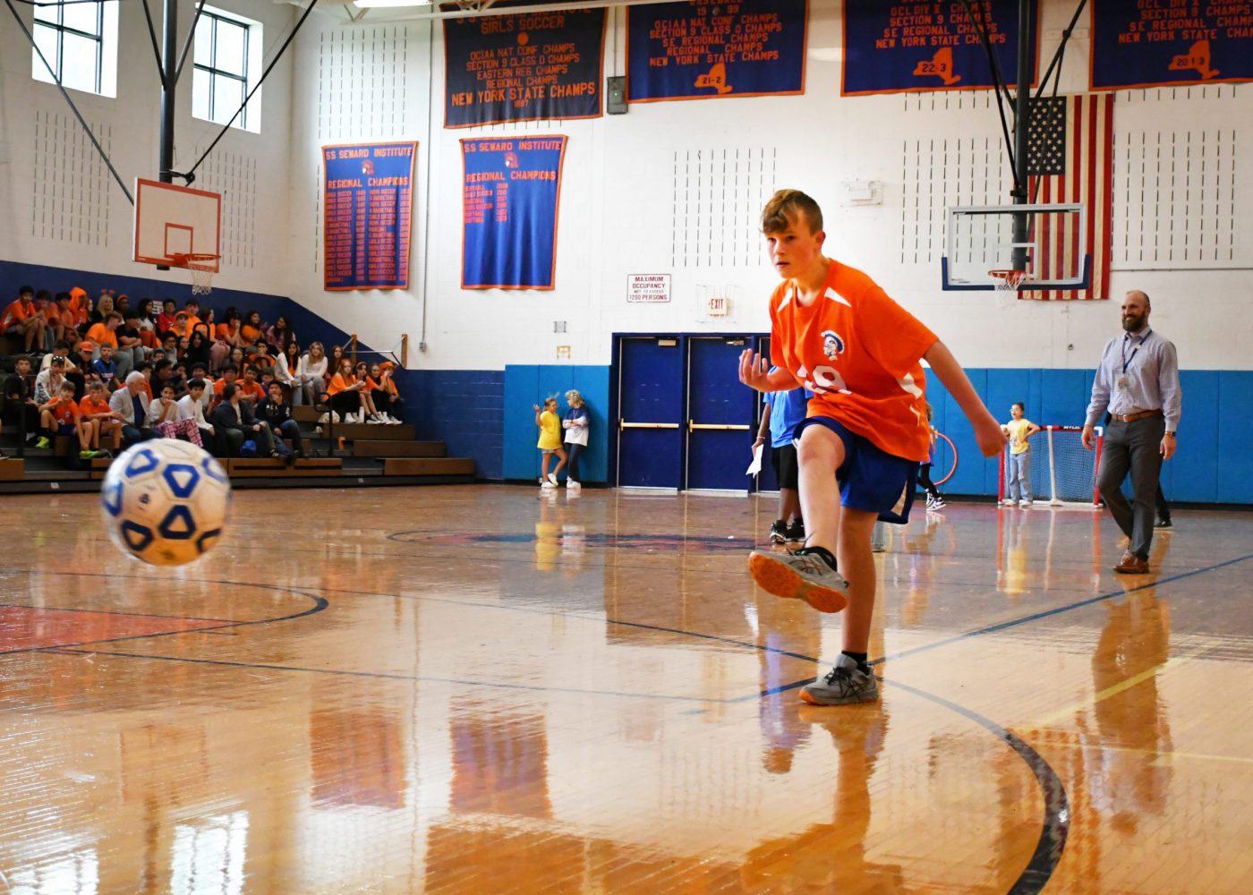 student participates in soccer drill during the pep rally