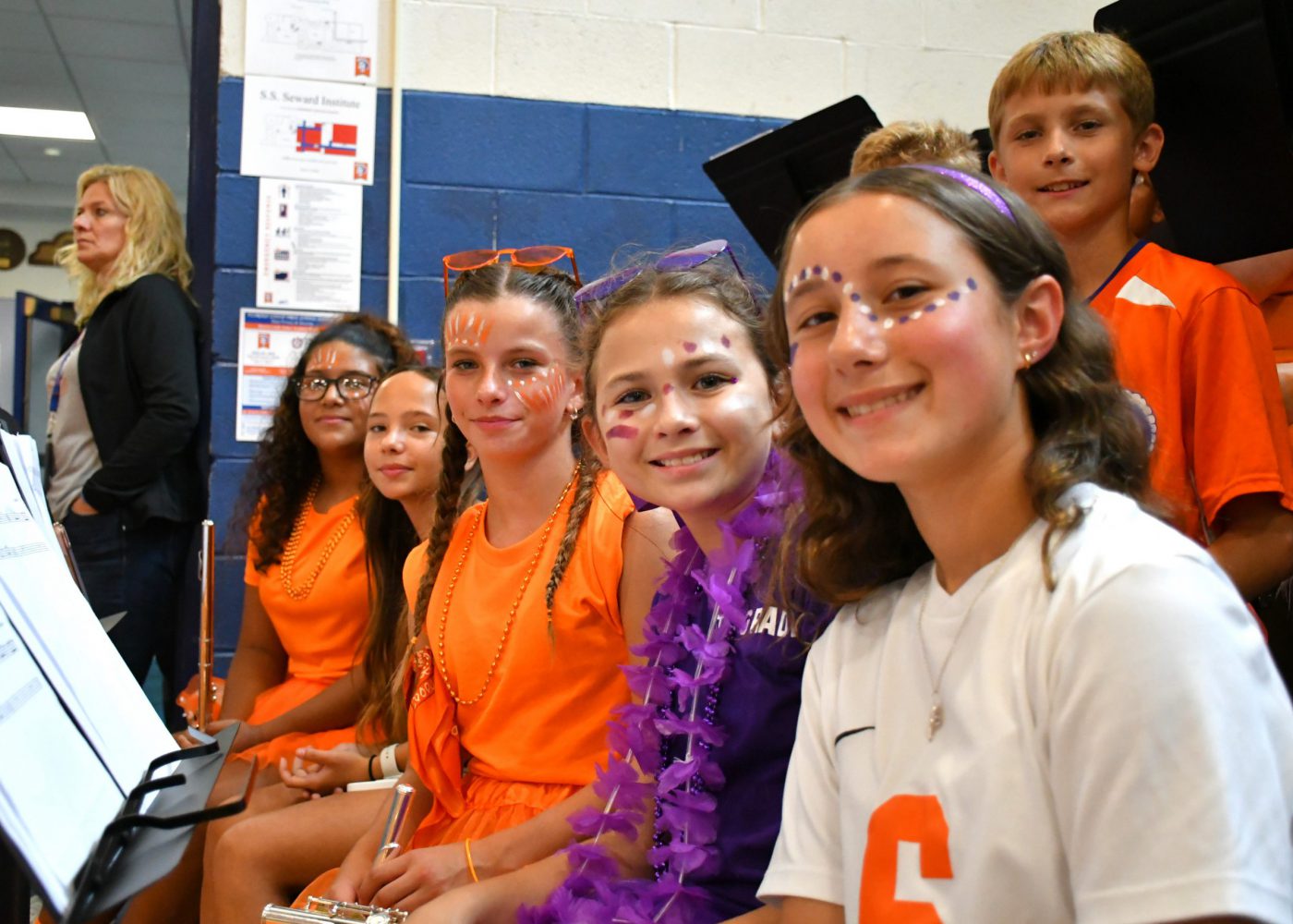 students in the band smile for the camera