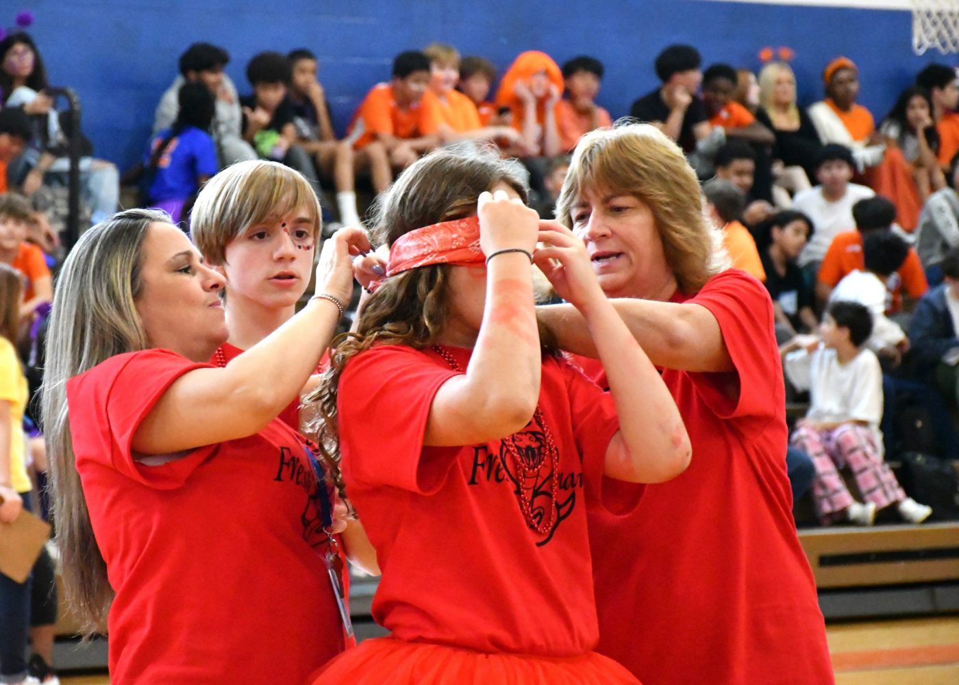 staff help blindfold student for game