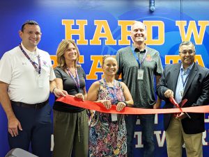 Board of education cuts the ribbon at weight room ribbon cutting ceremony