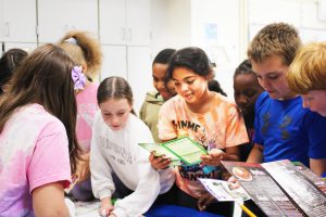 students gather around to select menus for their math activity