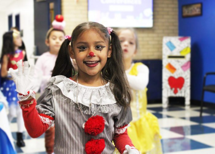 student smiles while heading to the costume parade