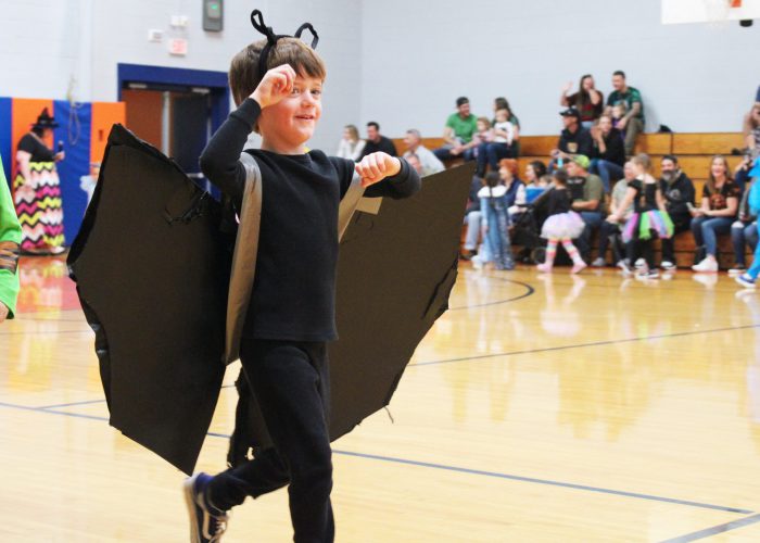 student dressed as bat at costume parade