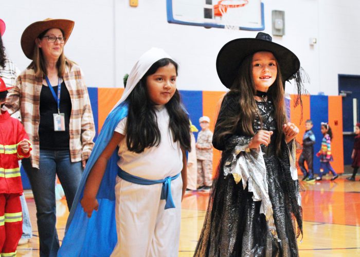 student dressed as a witch smiles at the camera