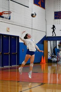 athlete serves volleyaball