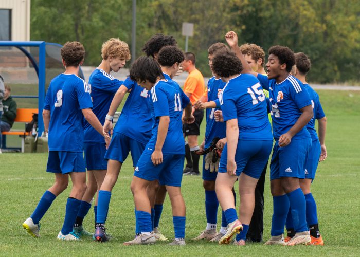 team comes together before game