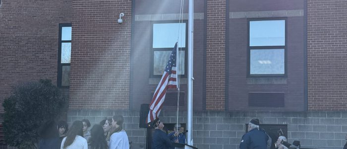 Veterans raised flag while select choir sang