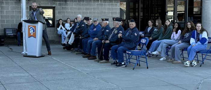 Veterans sat in front of students at flag raising ceremony