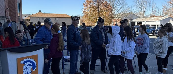 Students shake veterans hands after flag raising ceremony