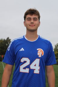 Aidan Vogt smiles in his soccer uniform