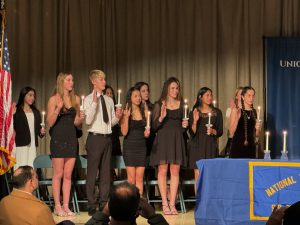 Students raise hand to be inducted into NHS