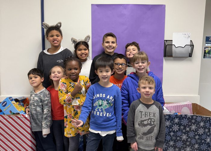 Students pose with toys they collected