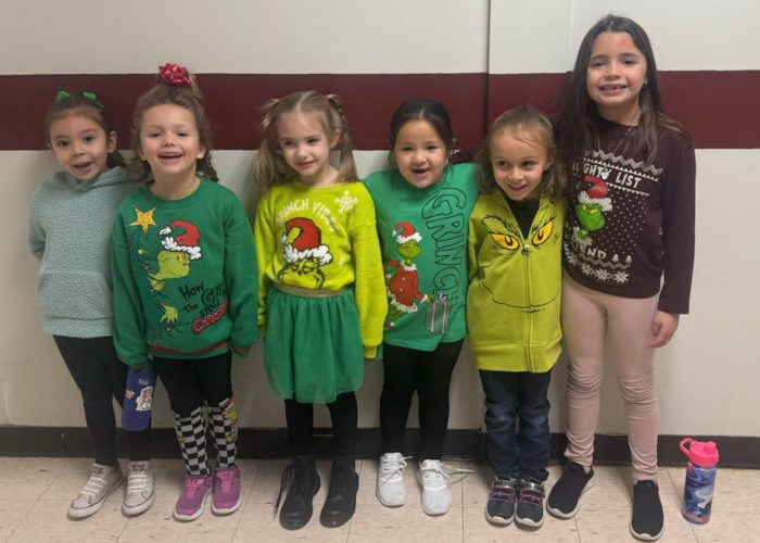 Elementary students dressed in green grinch outfits for spirit week.