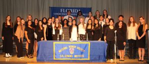 Group of students pose on stage for NHS induction