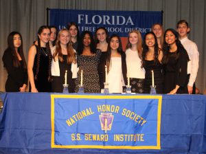 Students pose on stage for NHS induction