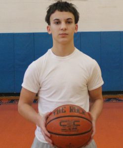 Basketball student posing with basketball