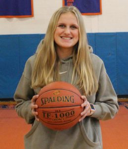 Basketball student posing with basketball