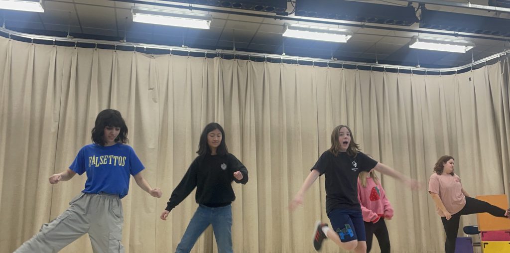 Drama students practice on stage