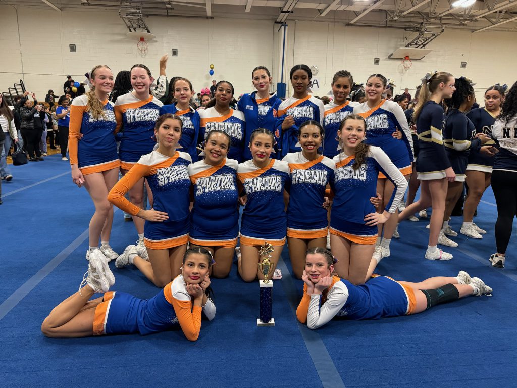 Cheer team poses together at cheer competition