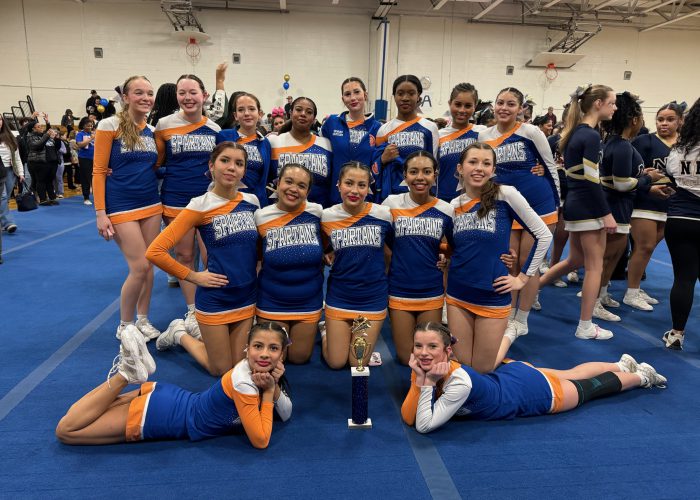 Cheer team poses together at cheer competition