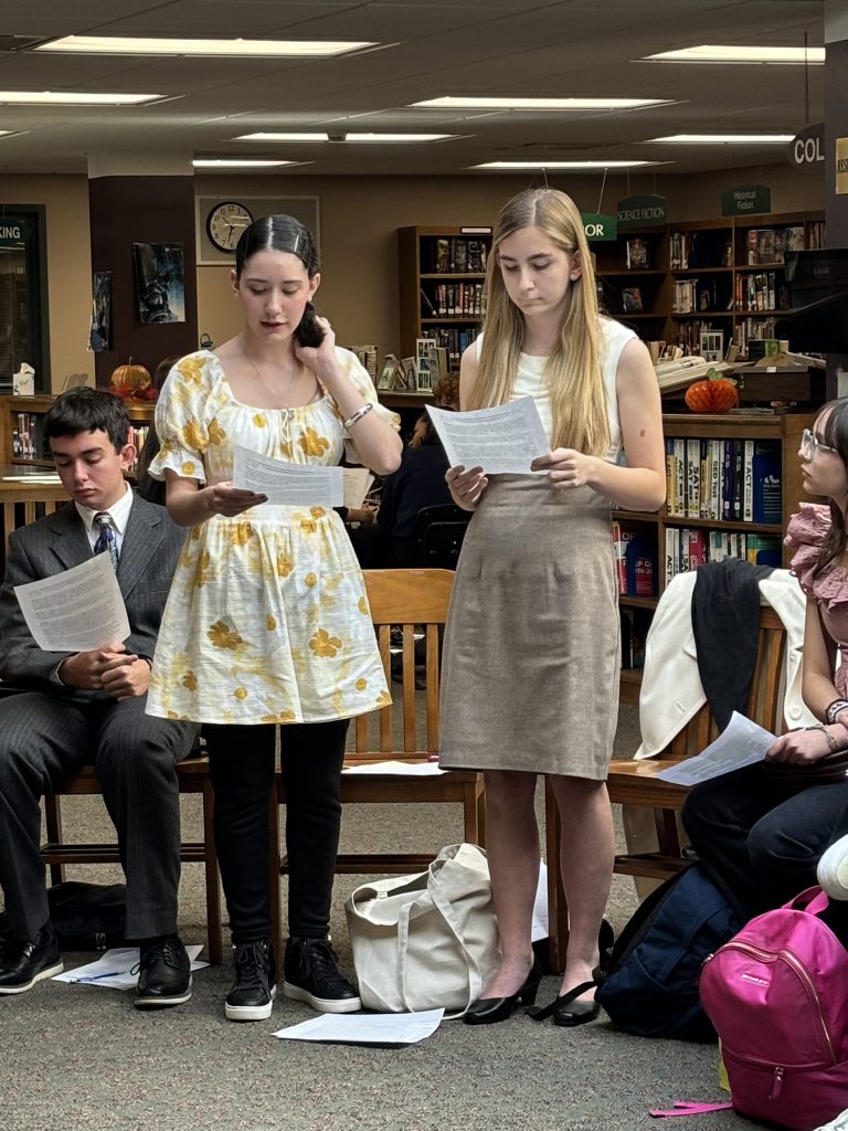 Students read notes from youth in government meeting